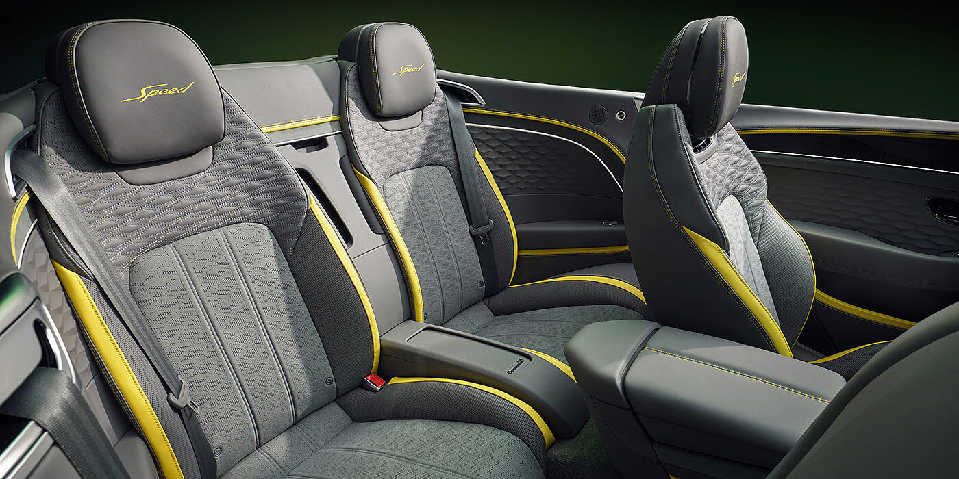 Bentley Almaty Bentley New Continental GTC Speed convertible rear interior with unique Speed colour split in Gravity Grey and Cyber Yellow hide colours, and contrast stitched headrest emblems 